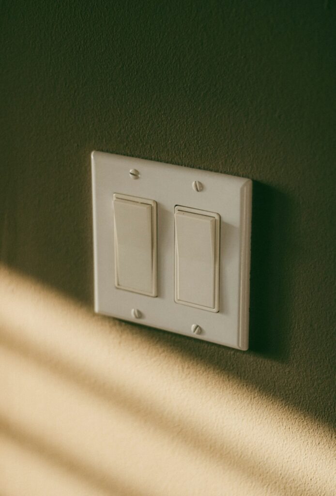 Double light switch on a painted wall