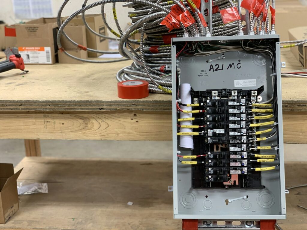 Residential electrical panel with breakers and new wiring on a workbench