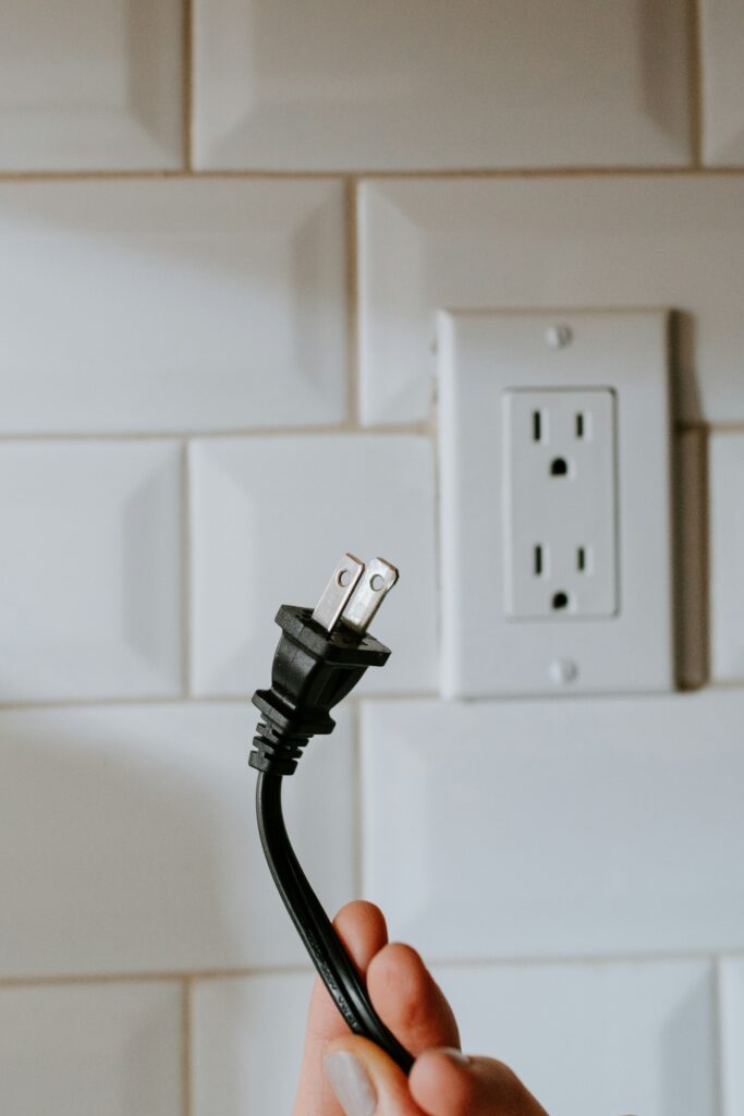 Standard wall outlet with a cable plugged in